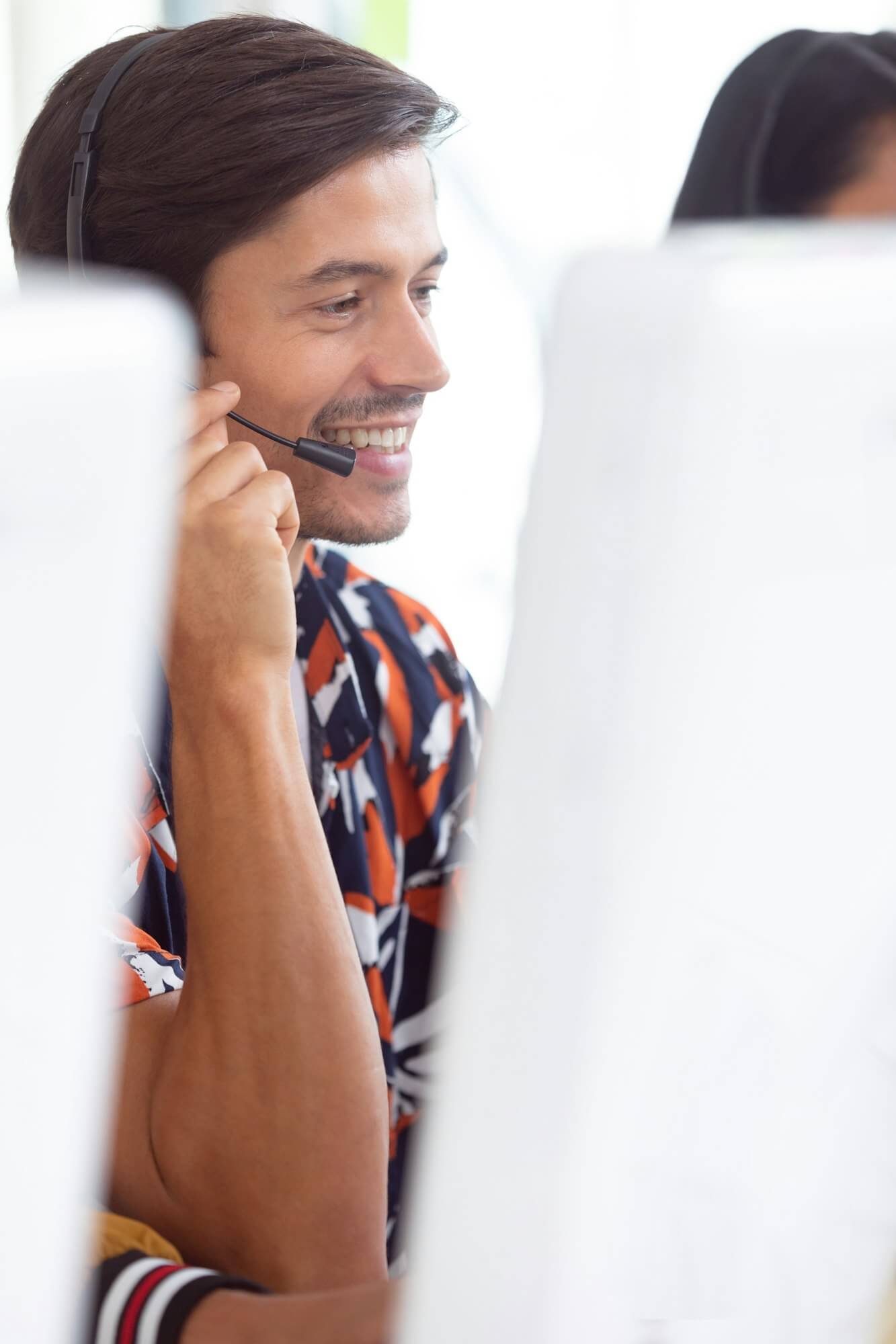 Side view of Caucasian male customer service executive working on computer at desk in office